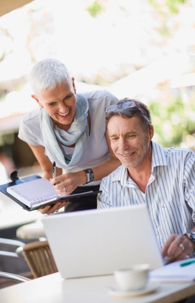 Business people using laptop outdoors